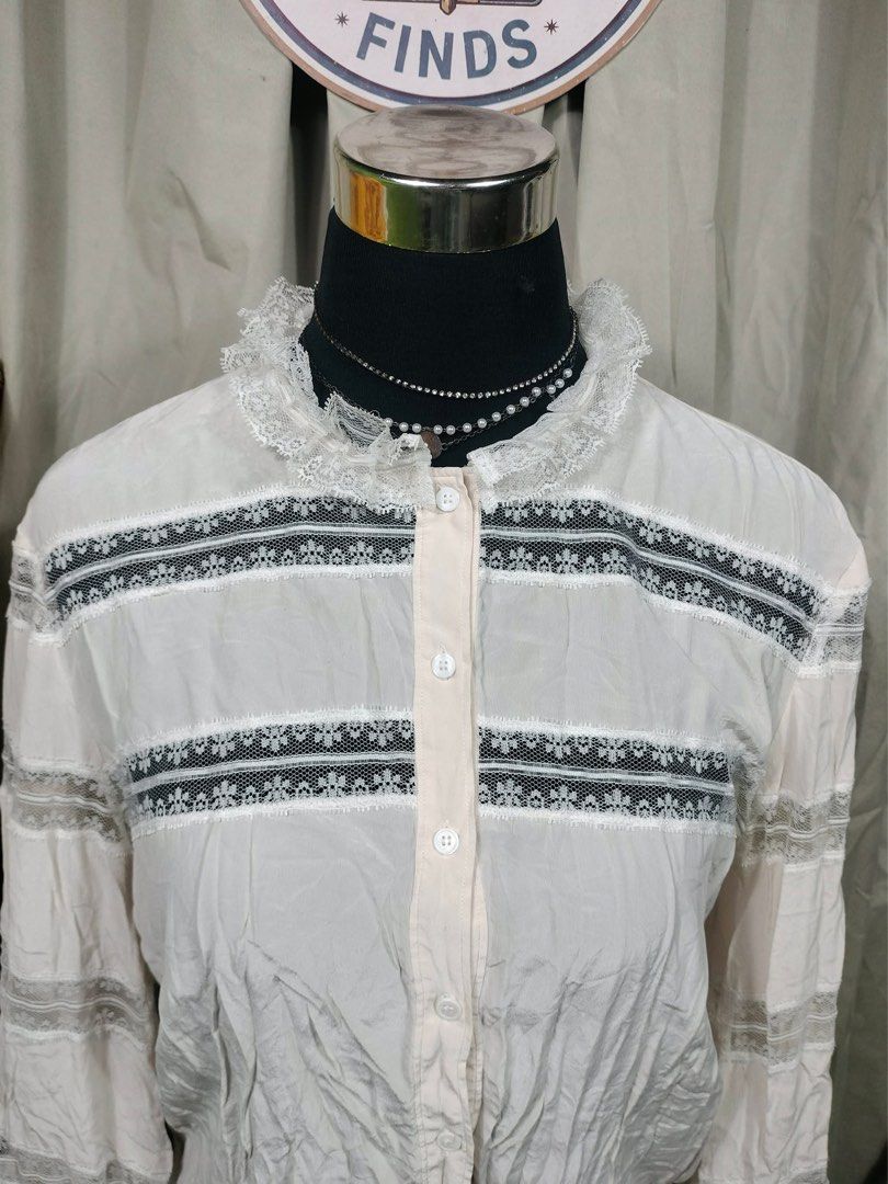 SANDRO White Lace Trimmed Blouse (Category: Blouses) located in Manila. Submitted by yesterdaysfinds (Listing ID 1461715225, Image 3). Description: - White long-sleeved blouse - Delicate lace trim on collar and sleeves - Button-up front - Slightly crinkled fabric texture - Perfect for a vintage-inspired look - Versatile: pairs well with skirts or trousers.