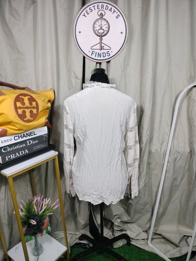 SANDRO White Lace Trimmed Blouse (Category: Blouses) located in Manila. Submitted by yesterdaysfinds (Listing ID 1461715225, Image 2). Description: - White long-sleeved blouse - Delicate lace trim on collar and sleeves - Button-up front - Slightly crinkled fabric texture - Perfect for a vintage-inspired look - Versatile: pairs well with skirts or trousers.
