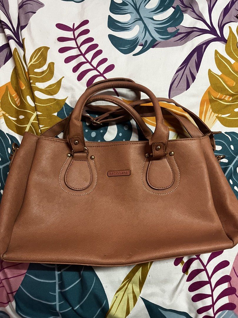 Secosana Satchel Handbag (Category: Purses & Pouches) located in Caloocan City. Submitted by evermoonlit (Listing ID 1461566475, Image 2). Description: - Brand: MCCASA - Material: Faux Leather - Color: Brown - Style: Satchel Handbag - Features: Top handles, detachable shoulder strap, interior pockets - Design: Classic, spacious, perfect for everyday use.
