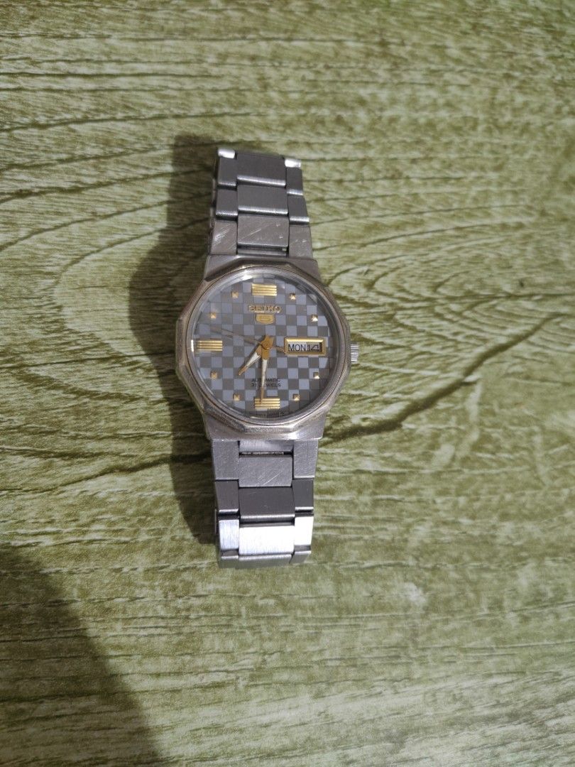 Seiko 5 Automatic Watch - Grey Checkerboard Dial (Category: Men's Watches) located in Cebu City. Submitted by goodsnagoodspa (Listing ID 1461696767, Image 2). Description: - Vintage Seiko 5 Automatic Watch - Cool Grey Checkerboard Dial with Gold Accents - Day and Date Complication - Stainless Steel Bracelet - Automatic Movement, 23 Jewels - Signs of wear consistent with age (case & bracelet) - Classic timepiece for watch enthusiasts.