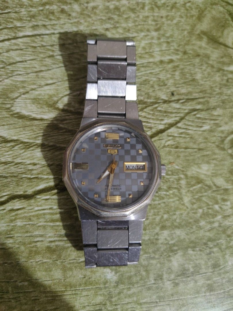 Seiko 5 Automatic Watch - Grey Checkerboard Dial (Category: Men's Watches) located in Cebu City. Submitted by goodsnagoodspa (Listing ID 1461696767, Image 1). Description: - Vintage Seiko 5 Automatic Watch - Cool Grey Checkerboard Dial with Gold Accents - Day and Date Complication - Stainless Steel Bracelet - Automatic Movement, 23 Jewels - Signs of wear consistent with age (case & bracelet) - Classic timepiece for watch enthusiasts.