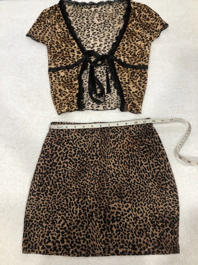 SHEIN Leopard Print Top and Skirt Set (Category: Sets or Coordinates) located in Manila. Submitted by janmichael26601 (Listing ID 1461615876, Image 1). Description: - Cute SHEIN leopard print top and skirt set - Top features short sleeves and a tie-front closure with lace trim - Skirt is mini length - Both items are size XXS - Ideal for a night out or a fun casual look - Measurements provided in photos.