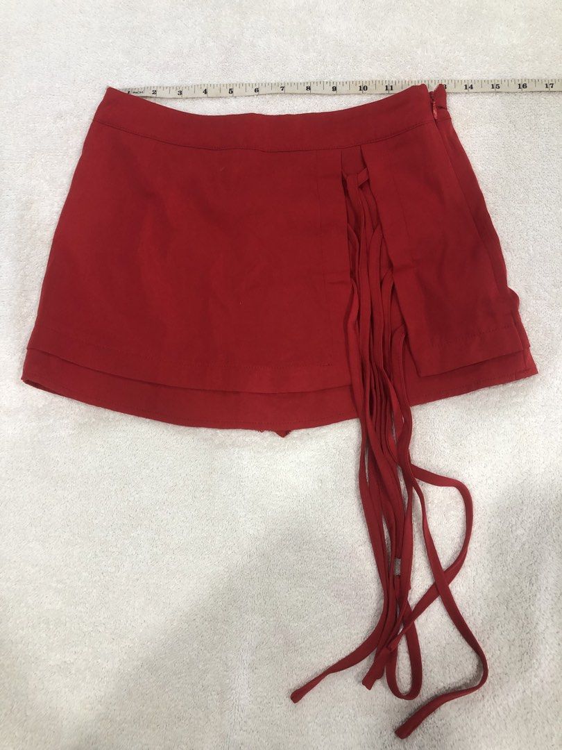 SHEIN Red Fringed Mini Skirt (Category: Skirts) located in Manila. Submitted by janmichael26601 (Listing ID 1461611150, Image 1). Description: - Red mini skirt from SHEIN - Features cute fringe detail on the side - Zipper closure for easy wear - Versatile for night outs or casual days - Pairs well with simple tops.