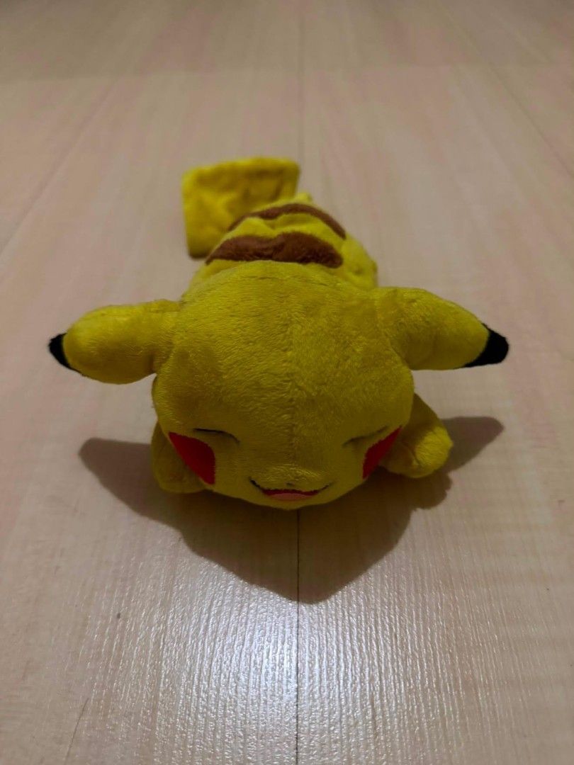 Sleeping / Lying Down Pikachu Plush Strap Cover Holder (will be extra cleaned for ur sake) (Category: Character Goods) located in Quezon City. Submitted by chennister (Listing ID 1461735035, Image 1). Description: Authentic Pokémon Sleeping Pikachu plush pouch/holder featuring a cute lying-down pose with sleeping embroidered eyes. Equipped with adjustable yellow clips on the underside to attach securely onto bag straps, backpacks, or seatbelts. I
