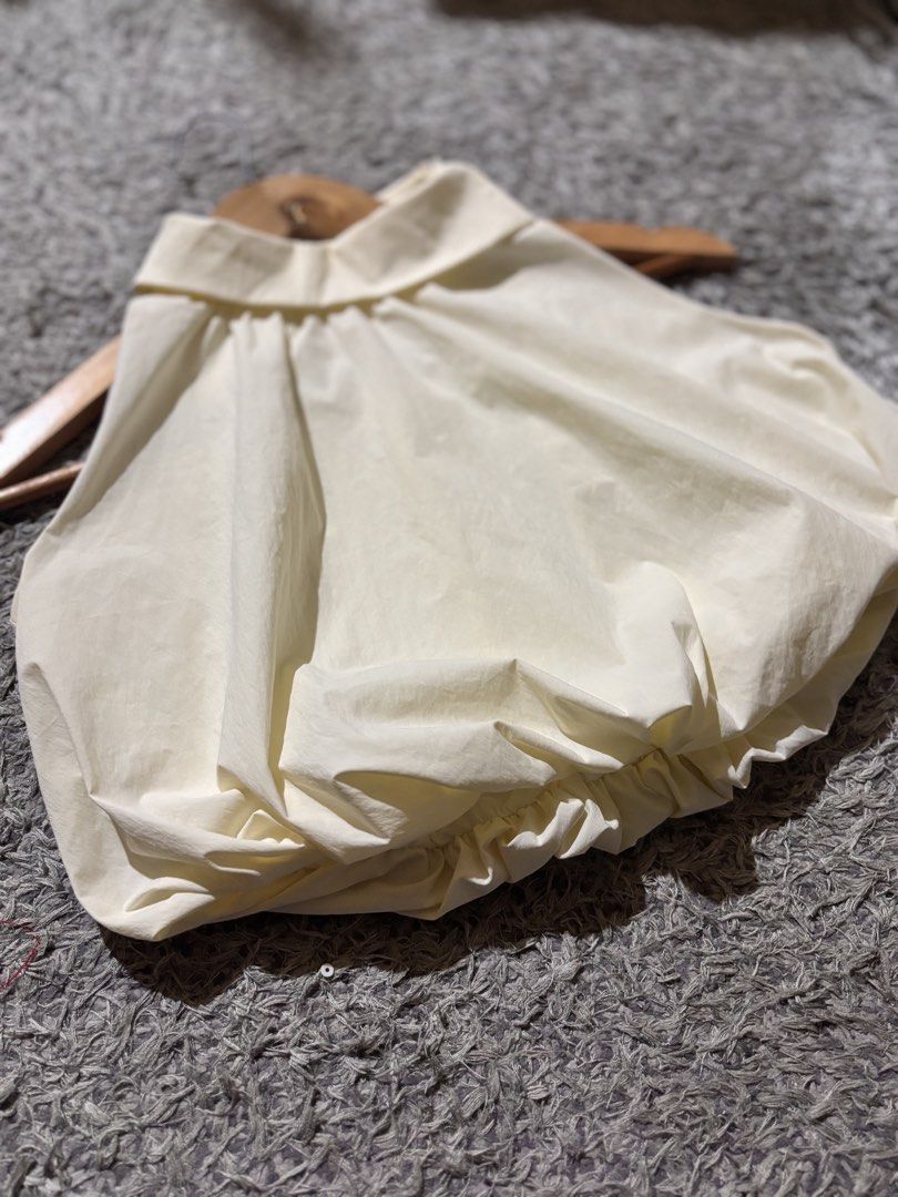 sleeveless halter top (Category: Blouses) located in Manila. Submitted by kattlacsamana (Listing ID 1461746516, Image 2). Description: This is a cream-colored sleeveless halter top featuring a distinct bubble hem Size: Small .