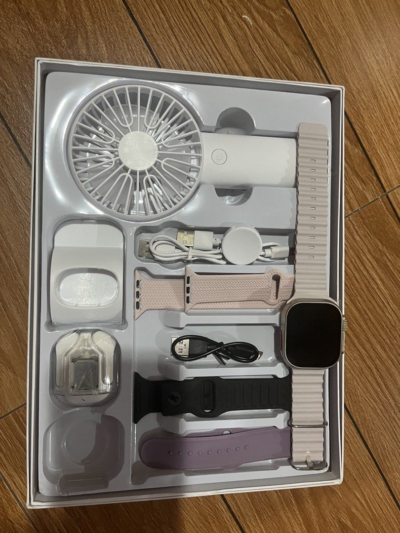 Smartwatch with Multiple Bands, Fan, and Charger (Category: Wearables & Smart Watches) located in Manila. Submitted by i_cyyy (Listing ID 1461564004, Image 2). Description: - Smartwatch set with multiple watch bands: pink, black, and purple. - Includes a rechargeable white portable fan. - Comes with a charging cable and a wireless charging puck. - All items are in their original packaging..