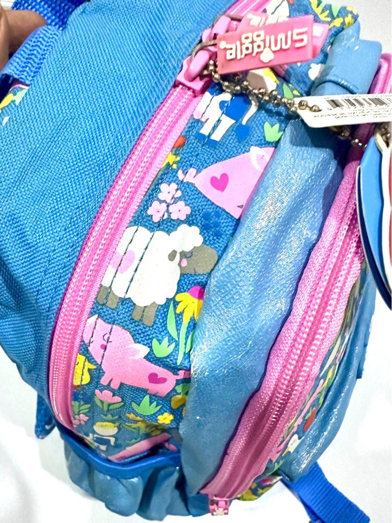 Smiggle Teeny Tiny Backpack - Farm Animals Print (Category: Babies & Kids Fashion) located in Antipolo. Submitted by shopaho_nique (Listing ID 1460239976, Image 3). Description: - Authentic Adorable Smiggle backpack for little ones - Fun farm animal print (pigs, ducks, cows, chickens) - Blue with pink trim and a sparkly front pocket - Adjustable straps for a comfortable fit - Convenient mesh side pocket - Ideal size for toddlers and preschoolers 