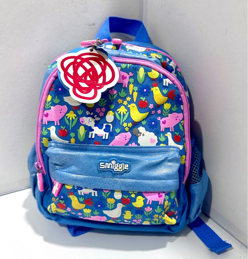 Smiggle Teeny Tiny Backpack - Farm Animals Print (Category: Babies & Kids Fashion) located in Antipolo. Submitted by shopaho_nique (Listing ID 1460239976, Image 1). Description: - Authentic Adorable Smiggle backpack for little ones - Fun farm animal print (pigs, ducks, cows, chickens) - Blue with pink trim and a sparkly front pocket - Adjustable straps for a comfortable fit - Convenient mesh side pocket - Ideal size for toddlers and preschoolers 