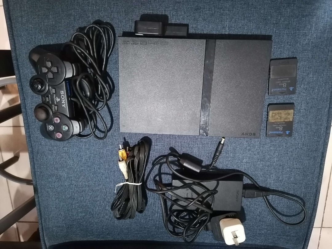 Sony PlayStation 2 Console Bundle with Controllers and Memory Cards (Category: PlayStation) located in Caloocan City. Submitted by coolmountain_b4ba30 (Listing ID 1461795514, Image 2). Description: - Sony PlayStation 2 Console - 1 Controller Included - 2 Memory Cards Included - All Necessary Cables and Power Adapter - Working, but unsure on video output - Ideal for Retro Gaming Enthusiasts Current available game: Kingdom Hearts.
