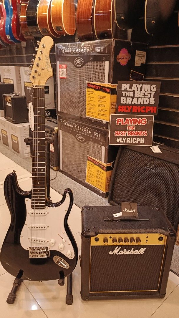 Stratocaster Severo Electric Guitar with Marshall MG15 Amplifier (Category: Musical Instruments) located in Manila. Submitted by johnoah213 (Listing ID 1461656532, Image 1). Description: - Black body electric guitar - White pickguard - Includes Marshall MG15 amplifier - Ideal starter pack for aspiring musicians.