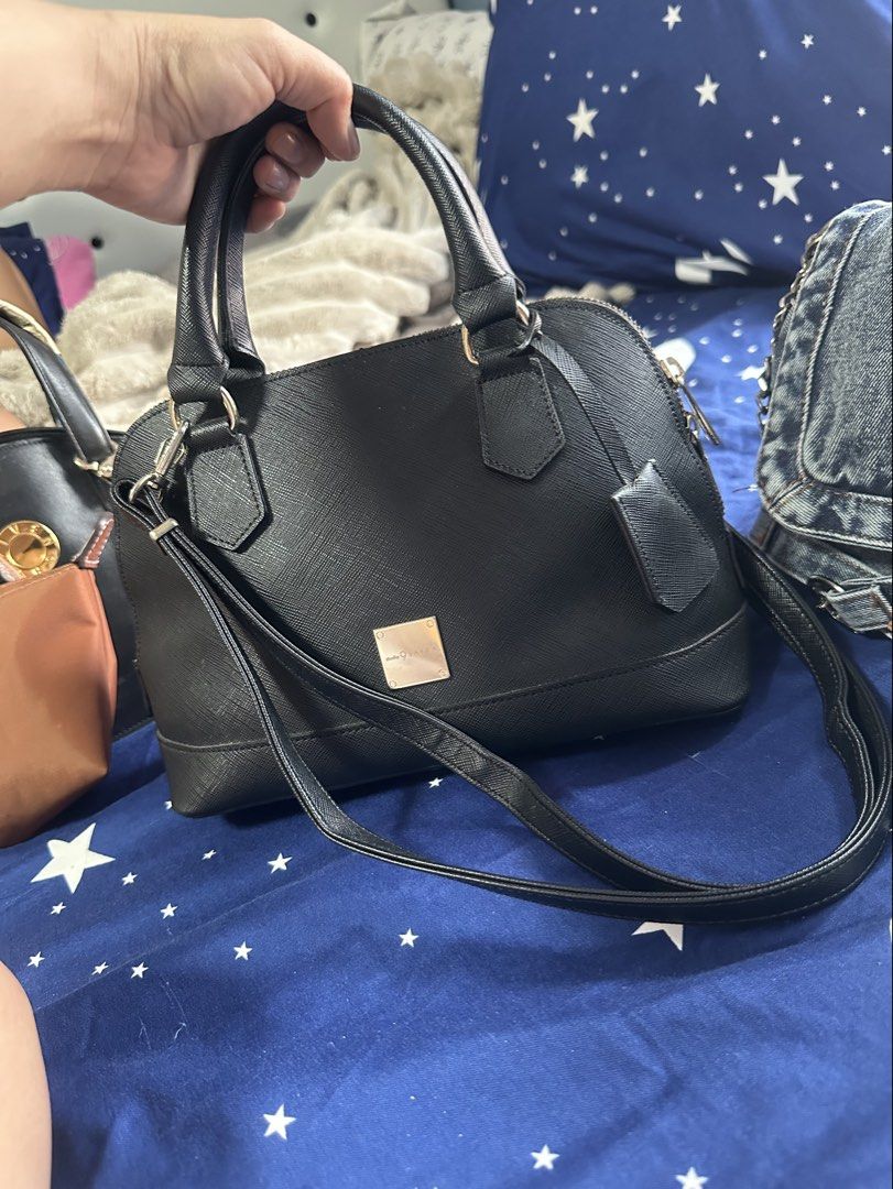 Studio 9 Saera Black Dome Satchel (Category: Shoulder Bags) located in Cebu City. Submitted by forless.ph (Listing ID 1461750254, Image 1). Description: featuring a textured saffiano finish, top-carry handles, gold-tone accents, a prominent square metal logo plate, and a matching detachable shoulder strap. .