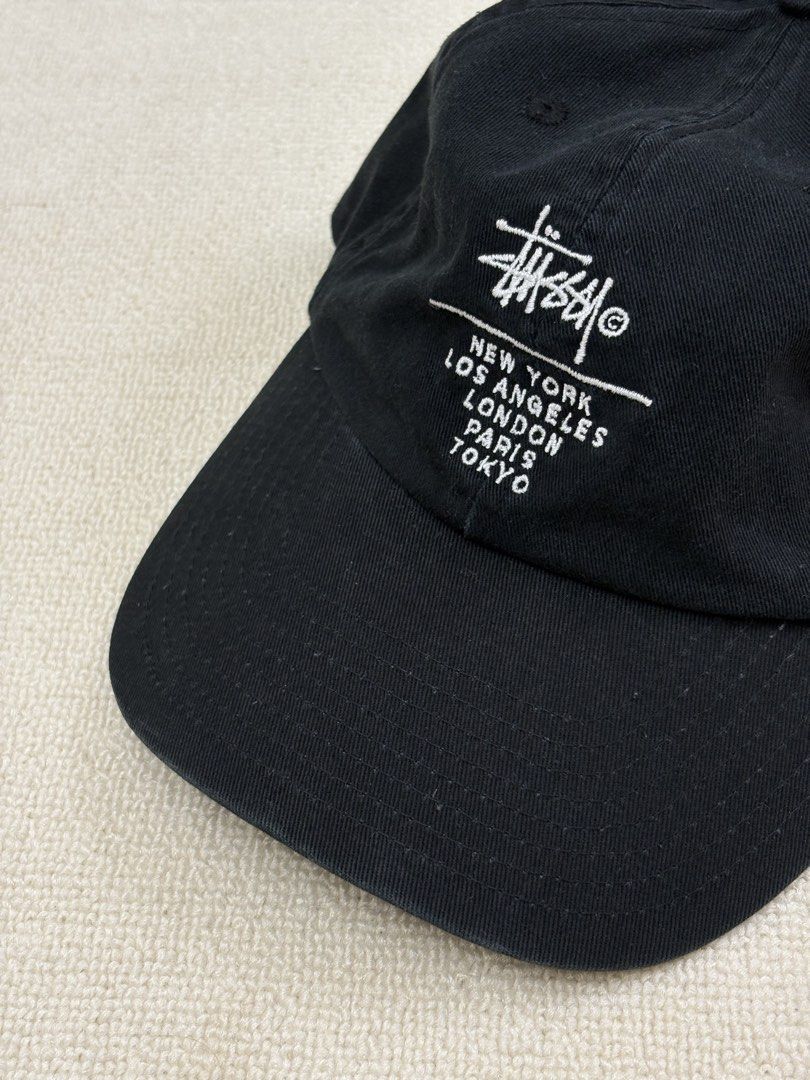 Stussy World Tour Cap Black (Category: Caps & Hats) located in Manila. Submitted by porma.market (Listing ID 1461577960, Image 1). Description: - Classic black Stussy cap - Features iconic Stussy logo - Embroidered World Tour locations: New York, Los Angeles, London, Paris, Tokyo - Adjustable strap for a comfortable fit - Ideal for everyday wear.