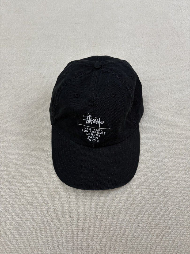 Stussy World Tour Cap Black (Category: Caps & Hats) located in Manila. Submitted by porma.market (Listing ID 1461577960, Image 2). Description: - Classic black Stussy cap - Features iconic Stussy logo - Embroidered World Tour locations: New York, Los Angeles, London, Paris, Tokyo - Adjustable strap for a comfortable fit - Ideal for everyday wear.