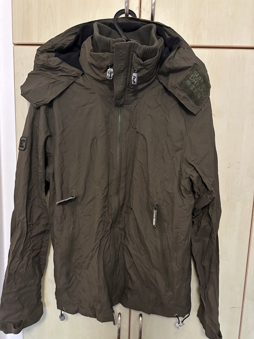 Superdry hooded windcheater Jacket (Category: Coats, Jackets and Outerwear) located in Quezon City. Submitted by mancave_stuff (Listing ID 1461647820, Image 3). Description: - Superdry Jacket - Color: Olive Green - Size: Large (W22” x L29”) - Features: Hood, multiple zip pockets - Adjustable hem with drawstrings - Ideal for outdoor activities and casual wear - Excellent condition. No issue.