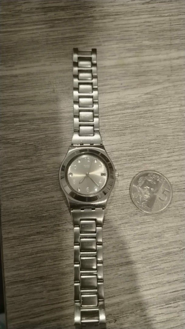 Swatch Watch Silver Metal Strap (Category: Women's Watches) located in Manila. Submitted by wildwind_73f77a (Listing ID 1461586634, Image 1). Description: - Genuine silver Swatch watch - Clean, minimalist watch face with silver markers - Classic metal link bracelet - Durable and stylish for everyday wear - Features Swatch logo and text on the back.