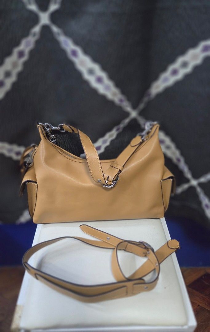 Tan Leather Shoulder Bag with Silver Chain (Category: Shoulder Bags) located in Quezon City. Submitted by affordabags_cd (Listing ID 1461682694, Image 2). Description: - Genuine tan leather shoulder bag - Elegant silver chain strap detail - Secure zipper closure - Light-colored fabric interior lining - Includes a detachable shoulder strap for versatile styling - Proudly made in Vietnam.