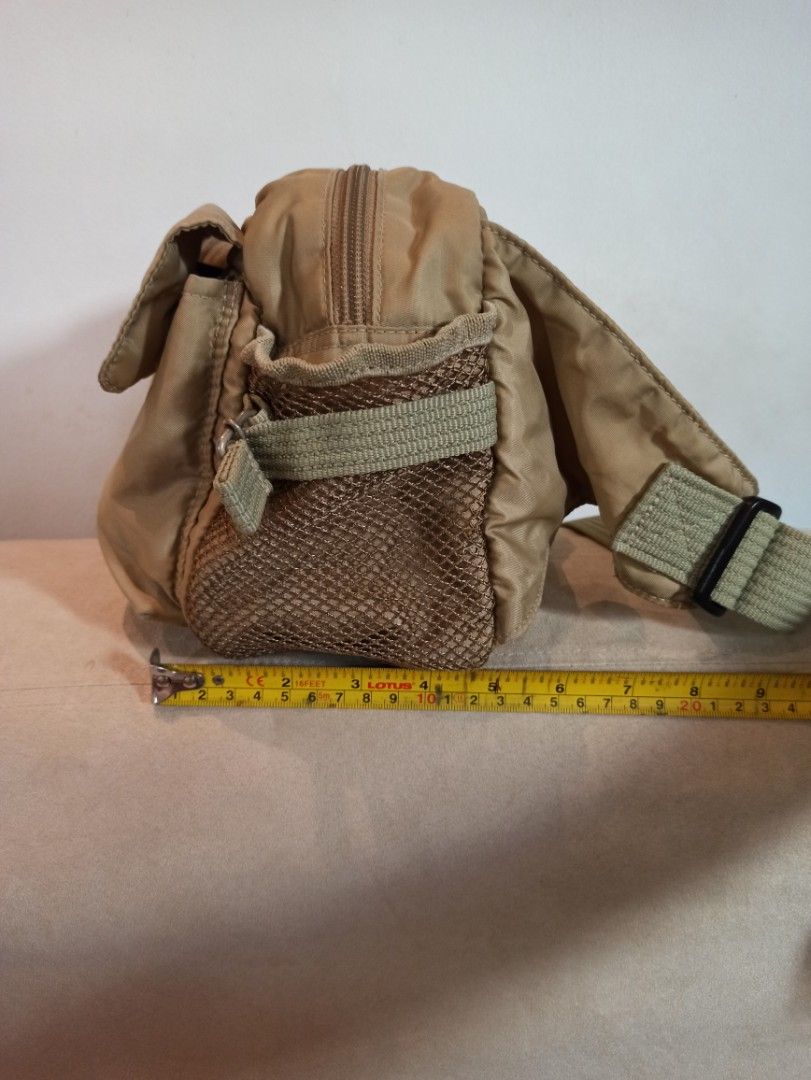 Tan Nylon Yubi Belt Bag with Multiple Pockets - Unisex (Category: Cross-body Bags) located in Caloocan City. Submitted by rtarellano (Listing ID 1461576567, Image 2). Description: - Yubi Durable tan nylon belt bag, Japan brand Unisex - Main compartment with zipper closure - Two front zippered pockets - Front flap pocket - Convenient side mesh pocket - Adjustable strap with buckle - Ideal for everyday errands or travel adventures.
