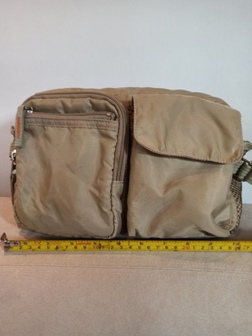 Tan Nylon Yubi Belt Bag with Multiple Pockets - Unisex (Category: Cross-body Bags) located in Caloocan City. Submitted by rtarellano (Listing ID 1461576567, Image 1). Description: - Yubi Durable tan nylon belt bag, Japan brand Unisex - Main compartment with zipper closure - Two front zippered pockets - Front flap pocket - Convenient side mesh pocket - Adjustable strap with buckle - Ideal for everyday errands or travel adventures.