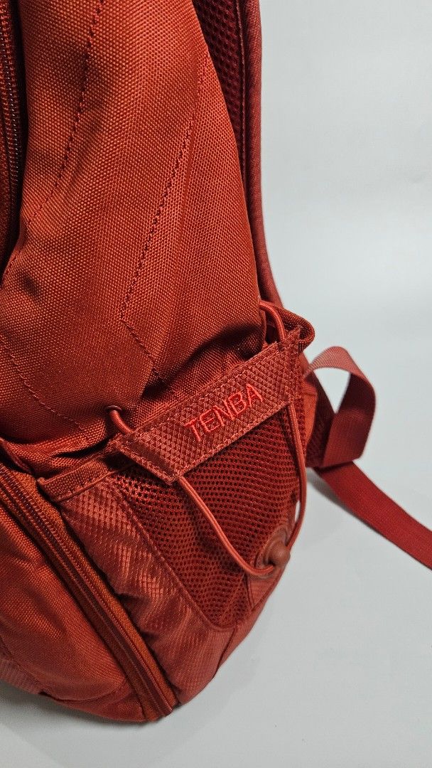 Tenba Red Camera Backpack Bag (Category: Camera Bags & Carriers) located in Alfonso. Submitted by jbcamet (Listing ID 1461711210, Image 2). Description: - Red Tenba backpack - Ample interior compartments with padded dividers for gear protection - Front pocket for quick access to smaller items - Convenient side pockets - Integrated rain cover for all-weather use - Ideal for photographers needing a portable and organized solution.