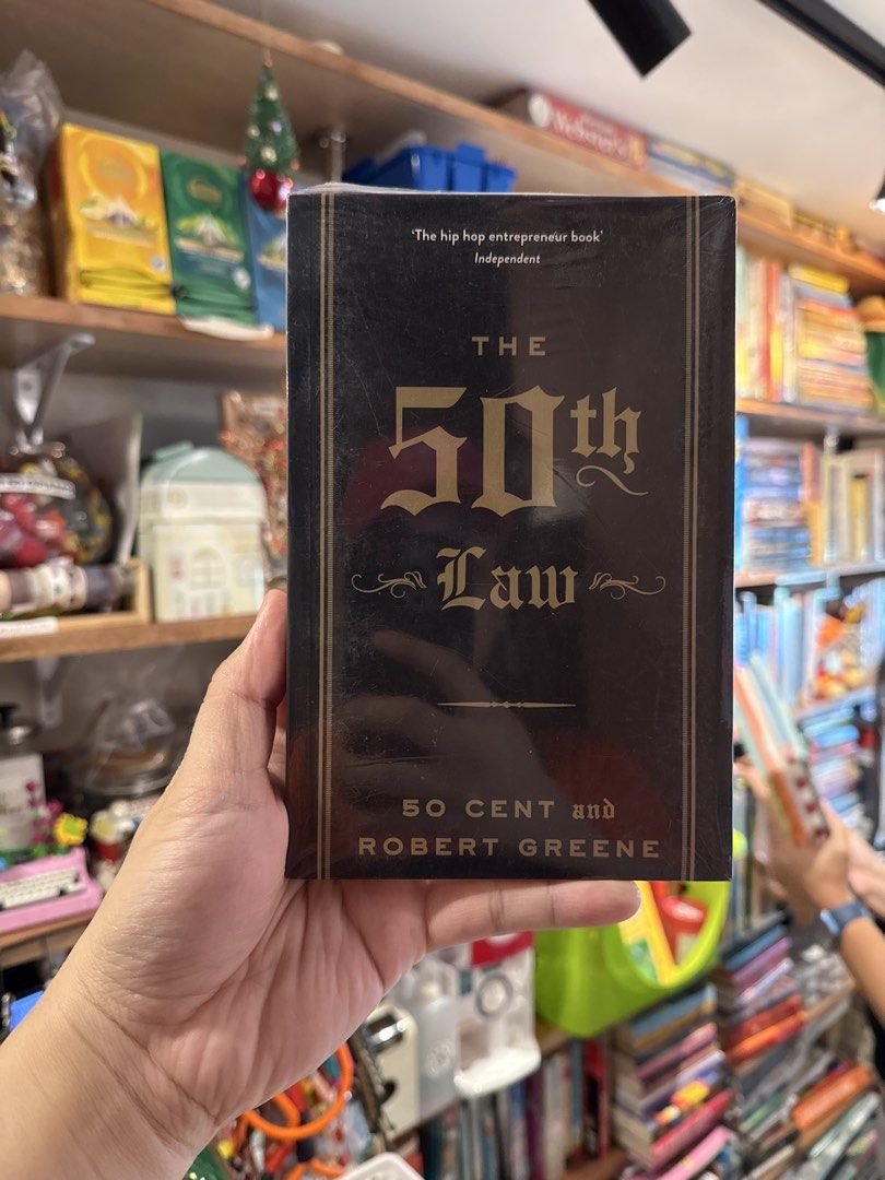 The 50th Law by 50 Cent and Robert Greene (Category: Storybooks) located in Marikina City. Submitted by starlettonabudget (Listing ID 1461657935, Image 1). Description: - 'The 50th Law' by 50 Cent & Robert Greene - Dubbed 'The hip hop entrepreneur book' - Features the motto 'nihil timendum est' (fear nothing) - A guide to becoming a master strategist and supreme realist - Excellent for business and personal growth.