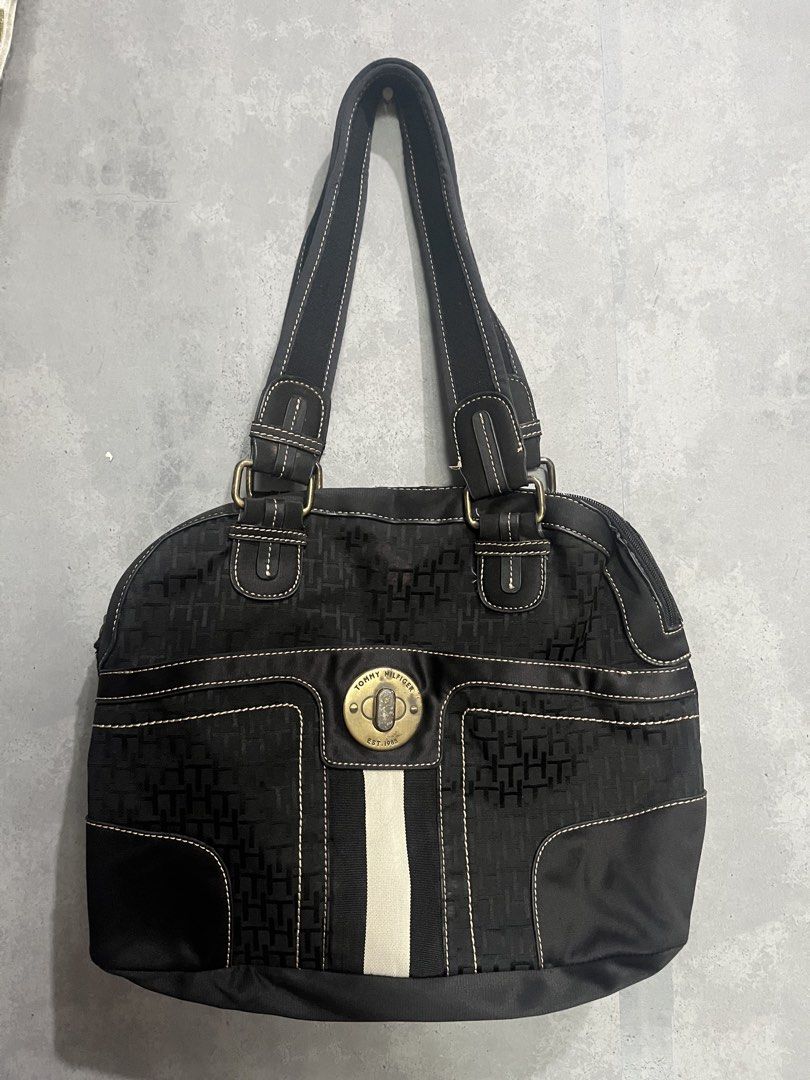 Tommy Hilfiger Black Monogram Tote Bag (Category: Tote Bags) located in Manila. Submitted by yk_thrifts7 (Listing ID 1461688954, Image 1). Description: - Classic black Tommy Hilfiger tote bag - All-over TH monogram pattern - Central white stripe detail - Gold-tone hardware - Black straps with white stitching - Spacious interior for essentials - Perfect everyday bag.
