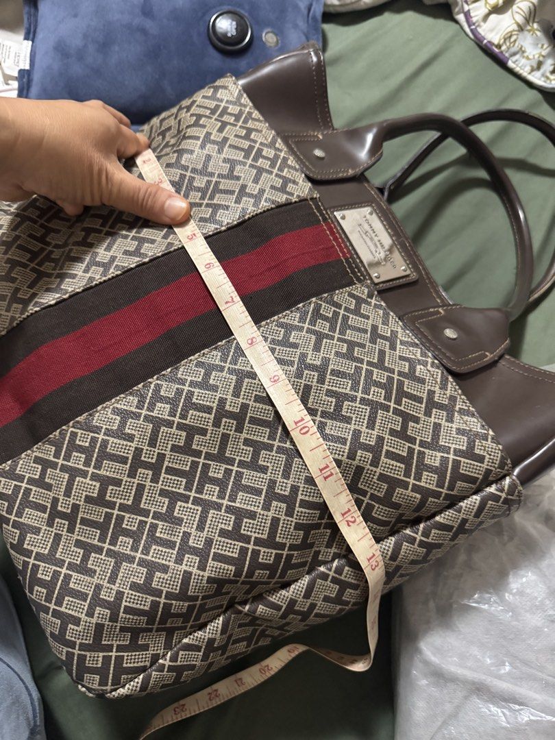 Tommy Hilfiger Monogram Tote Bag (Category: Tote Bags) located in Bacoor. Submitted by _ibyangf (Listing ID 1461795239, Image 3). Description: - Authentic Tommy Hilfiger tote bag - Signature monogram print - Brown leather accents and handles - Red and brown stripe detail - Approximate dimensions: 13" Height x 15" Width - Stylish and spacious for daily essentials J&T Delivery Gcash/Maya payment.
