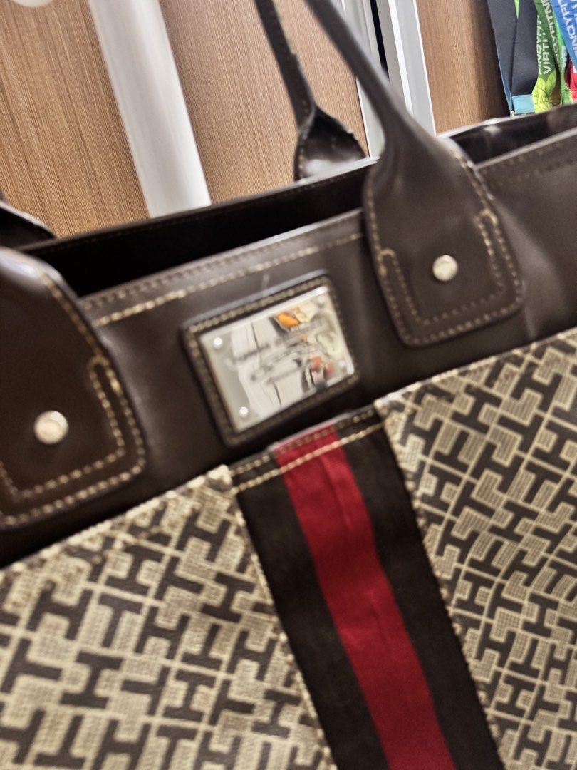 Tommy Hilfiger Monogram Tote Bag (Category: Tote Bags) located in Bacoor. Submitted by _ibyangf (Listing ID 1461795239, Image 2). Description: - Authentic Tommy Hilfiger tote bag - Signature monogram print - Brown leather accents and handles - Red and brown stripe detail - Approximate dimensions: 13" Height x 15" Width - Stylish and spacious for daily essentials J&T Delivery Gcash/Maya payment.