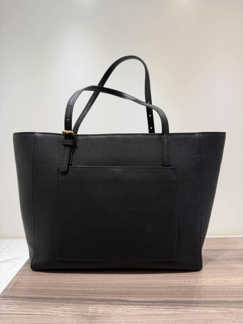 Tory Burch Black Leather Tote Bag (Category: Luxury Bags & Wallets) located in Caloocan City. Submitted by purefalcon.974eee (Listing ID 1461608493, Image 2). Description: - Classic black Tory Burch tote bag - Made of durable saffiano leather - Convenient front pocket - Two comfortable top handles - Signature gold Tory Burch logo on the front - Ample interior space for all your essentials - Ideal for everyday use.