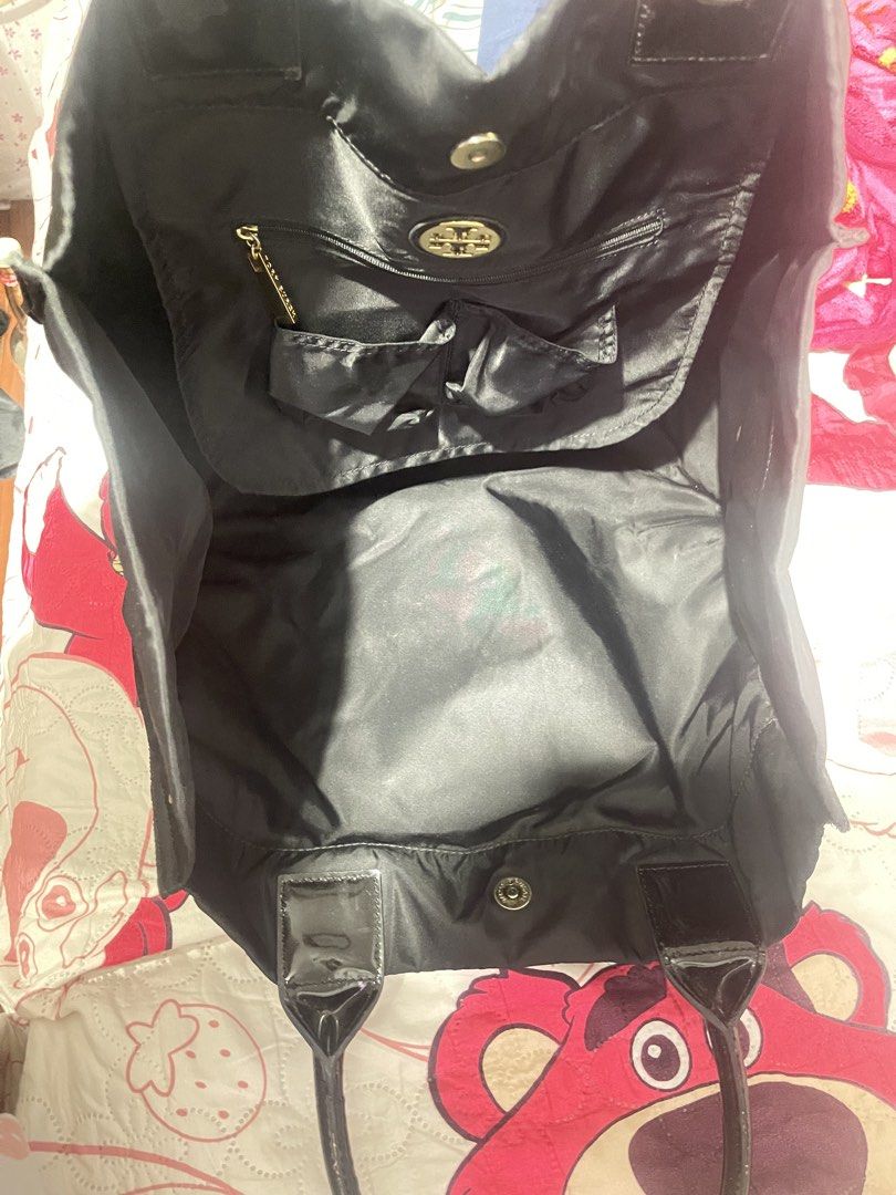 Tory Burch Black Nylon Tote Bag (Category: Tote Bags) located in Manila. Submitted by abeline07 (Listing ID 1461689035, Image 2). Description: - Classic black Tory Burch tote bag - Durable nylon with patent leather accents - Gold hardware details - Interior zip pocket and two slip pockets - Plenty of space, ideal for everyday use or travel.
