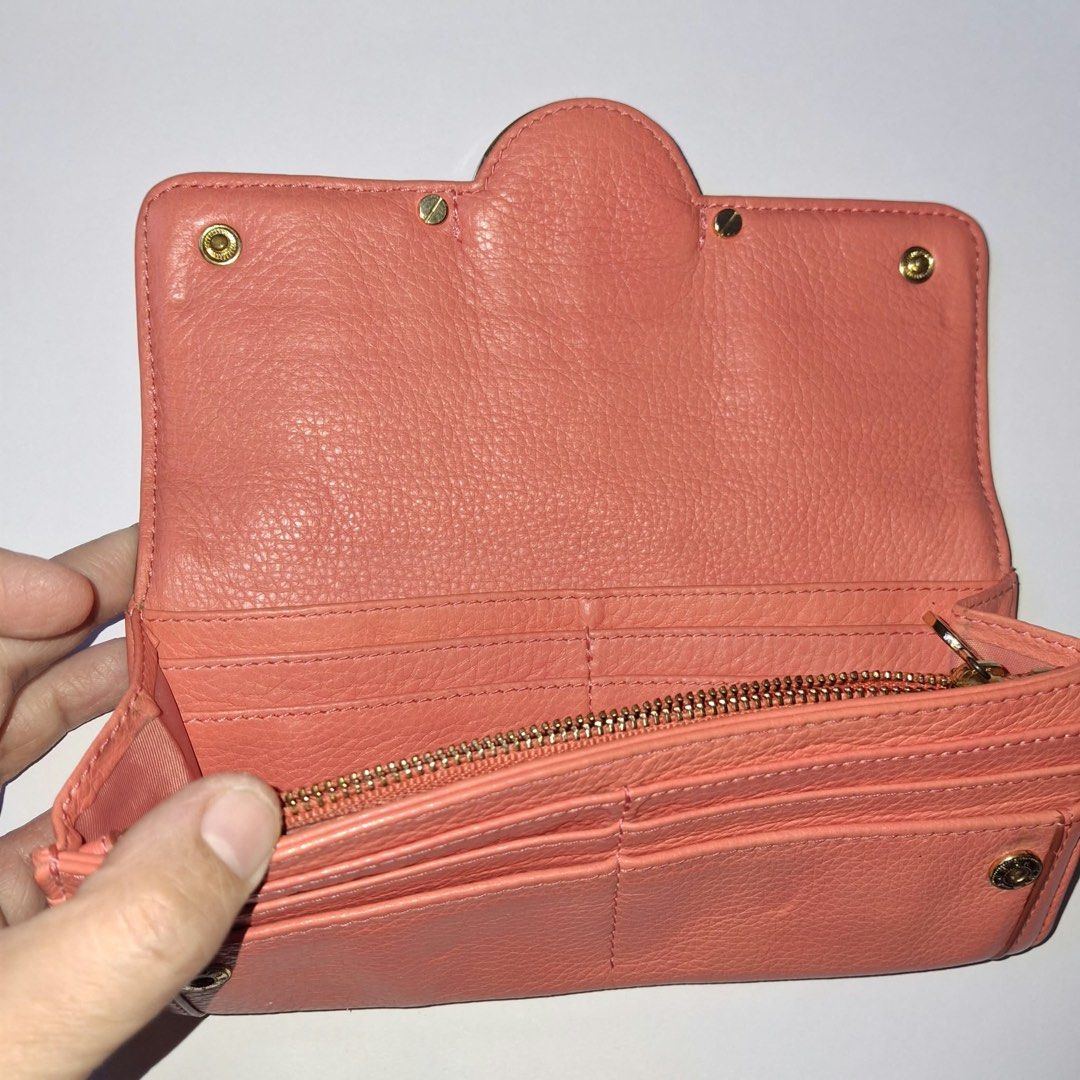 Tory Burch Pink Leather Trifold Wallet (Category: Luxury Bags & Wallets) located in Manila. Submitted by Mimi020623 (Listing ID 1461712469, Image 3). Description: - Brand: Tory Burch - Style: Trifold Wallet - Closure: Snap closure - Hardware: Gold hardware - Interior: Multiple card slots, zippered coin pocket - Benefit: Great for organizing essentials.