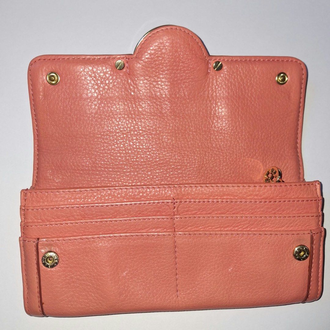 Tory Burch Pink Leather Trifold Wallet (Category: Luxury Bags & Wallets) located in Manila. Submitted by Mimi020623 (Listing ID 1461712469, Image 2). Description: - Brand: Tory Burch - Style: Trifold Wallet - Closure: Snap closure - Hardware: Gold hardware - Interior: Multiple card slots, zippered coin pocket - Benefit: Great for organizing essentials.