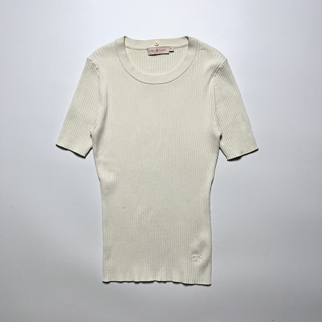 Tory Burch ribbed short-sleeve knit top (Category: Shirts) located in Cebu City. Submitted by franceuy (Listing ID 1461612585, Image 1). Description: Excellent Condition Issue: Stain (check last photo) need clean/wash only. W-12.5 L-23 Color rate: 9/10 Cebu City📍.