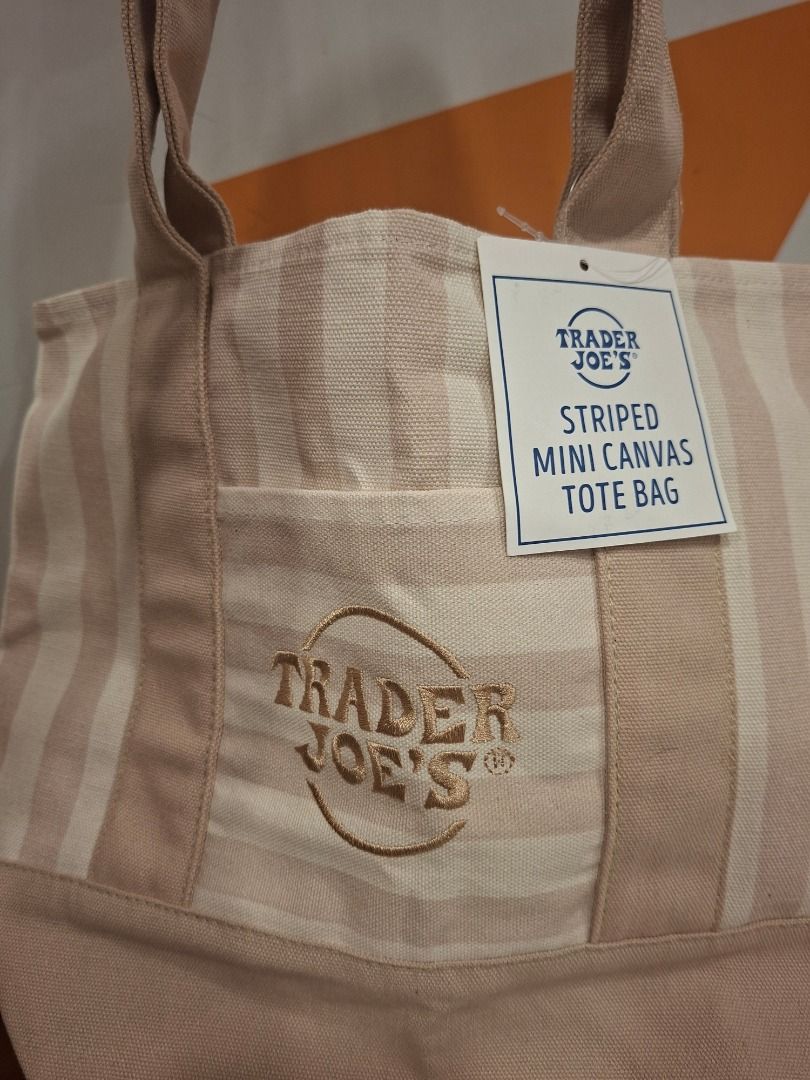 Trader Joe's Striped Mini Canvas Tote Bag (Category: Tote Bags) located in Makati City. Submitted by bocerelije18527 (Listing ID 1461757406, Image 1). Description: - Adorable mini canvas tote bag from Trader Joe's - Features a chic beige and white striped pattern - Convenient small front pocket for essentials - Embroidered Trader Joe's logo detail - Material: 65% Cotton, 35% Polyester - Origin: Product of Vietnam - Care Instructions: Machine wash