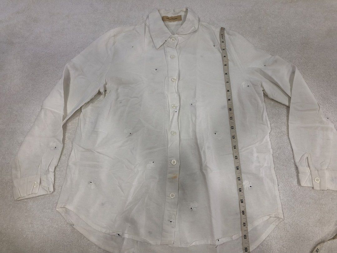 Triple Arrows White Embroidered Button-Up Shirt (Category: Longsleeves) located in Manila. Submitted by janmichael26601 (Listing ID 1461625425, Image 1). Description: - Brand: Triple Arrows - Style: White button-up shirt - Design: Adorable embroidered bunnies all over - Sleeves: Long sleeves with button cuffs - Flaw: Small stain on the front near the buttons - Measurements: Approx. 21" pit to pit, 27" length.