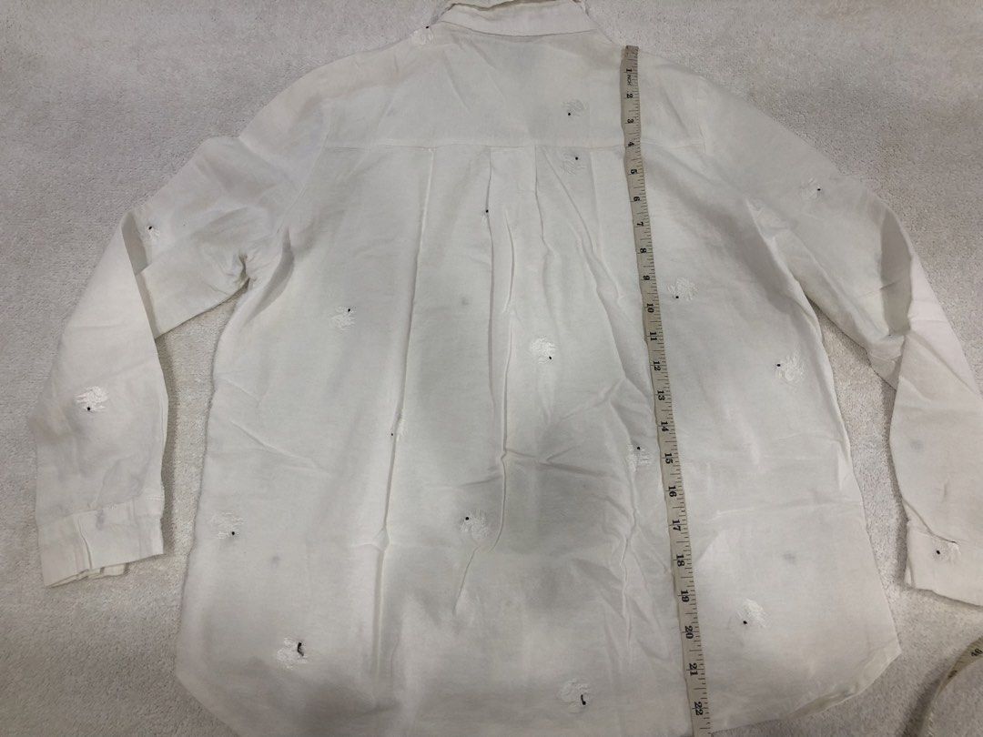 Triple Arrows White Embroidered Button-Up Shirt (Category: Longsleeves) located in Manila. Submitted by janmichael26601 (Listing ID 1461625425, Image 2). Description: - Brand: Triple Arrows - Style: White button-up shirt - Design: Adorable embroidered bunnies all over - Sleeves: Long sleeves with button cuffs - Flaw: Small stain on the front near the buttons - Measurements: Approx. 21" pit to pit, 27" length.