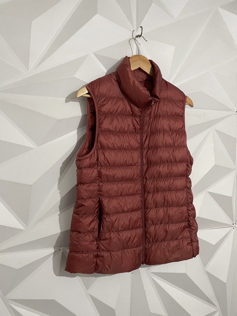 Uniqlo Ultra Light Down Vest - Red (Category: Sleeveless) located in Cabuyao City. Submitted by ParadisethriftedPh (Listing ID 1461782936, Image 3). Description: Cr: 9.8/10 Dimensions W: 20 L: 24.5 - Uniqlo Puffer Vest - Vibrant Red Color - Lightweight and Packable - Ideal for Layering - Perfect for Cooler Weather - Easy Zip-Up Design - Great for Casual Wear.