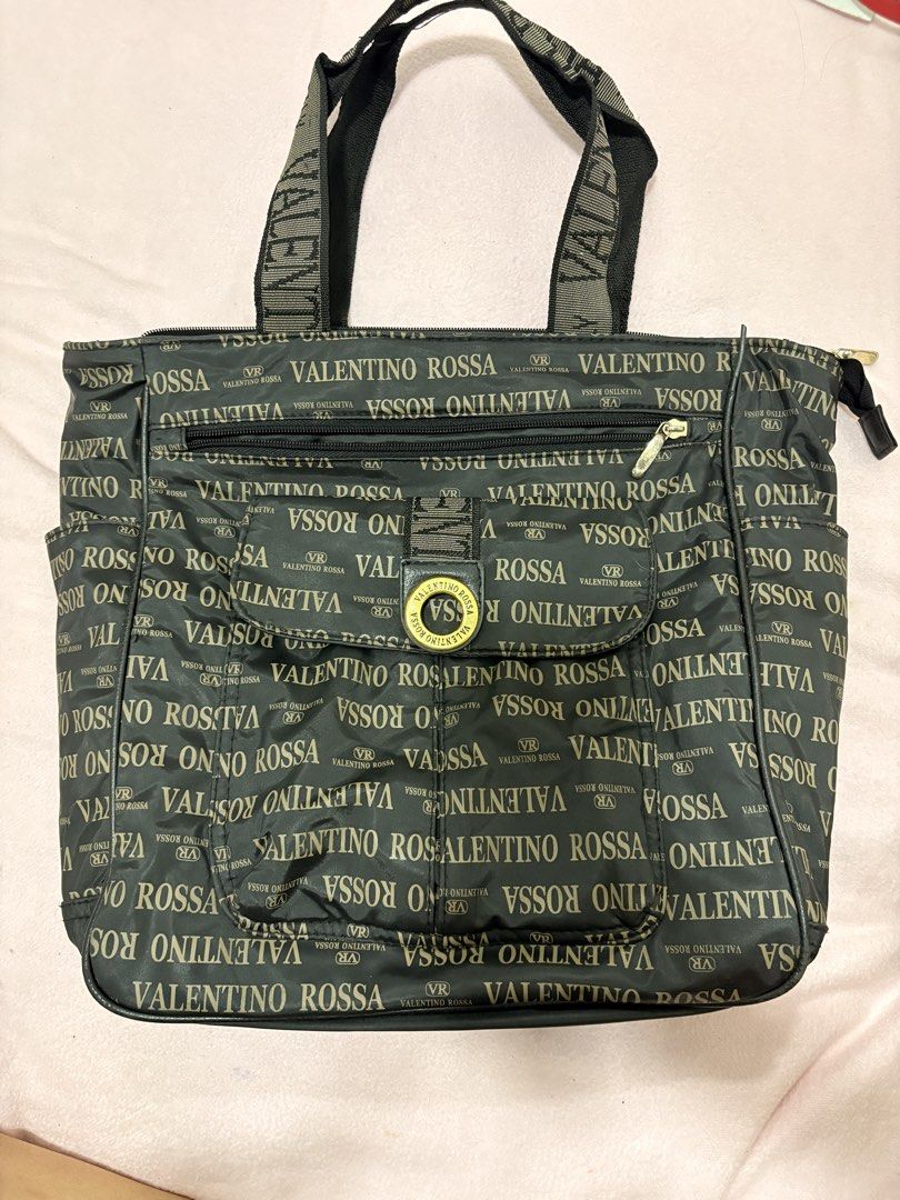 Valentino Rossa Monogram Tote Bag (Category: Luxury Bags & Wallets) located in Iligan City. Submitted by nebulanookph (Listing ID 1461600766, Image 1). Description: - Valentino Rossa tote bag - All-over logo print in gold lettering - Color: Dark brown - Zippered main compartment - Front pockets for easy access - Branded straps - Ideal size for everyday carry .