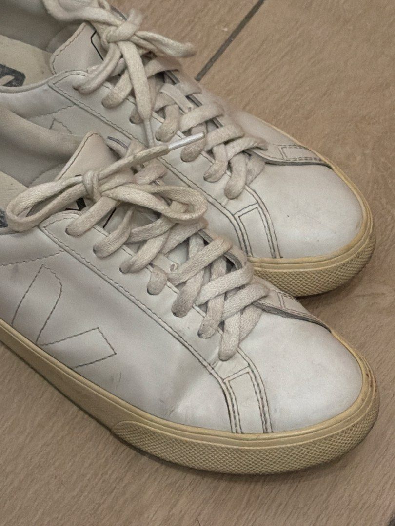 Veja White Leather Sneakers (Category: Sneakers) located in Taguig. Submitted by gabgabie (Listing ID 1461710230, Image 3). Description: - White leather Veja low-top sneakers - Signature V logo on the side - White laces - Light cream colored soles - Minor scuffs on leather and soles from regular wear - Plenty of life remaining - Ideal for everyday use - EU 37 / US 6.