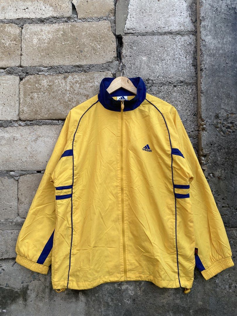 Vintage Adidas Track Jacket (Category: Activewear) located in Candaba. Submitted by dejesus.bench17 (Listing ID 1461792565, Image 1). Description: 90’s Vintage Adidas Track Jacket Embroid Logo -Color: Yellow/Blue -Condition: Excellent -Color rate: 9/10 -Issue: Need wash -Dimes: W23 L28 -Price: 750 + ship.