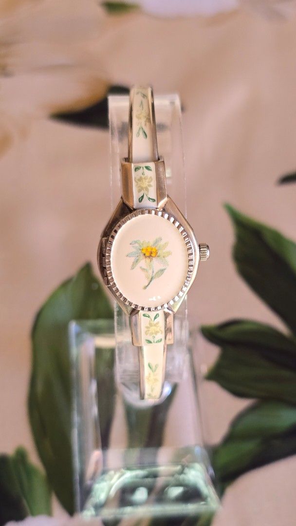 Vintage Andre Mouche Peekaboo Bangle Watch (Category: Women's Watches) located in Silang. Submitted by thewornhour (Listing ID 1461793811, Image 1). Description: Vintage André Mouche Swiss Enamel Bangle Watch – Hand-Painted Edelweiss Flower Locket ✔ All original watch ✔ Case: 16.8mm including crown ✔ Up to 16cm ✔ Movement: Precision Swiss Quartz ✔ Design: Unique piece features a rigid gold-tone bangle decorated with exquisite, hand-painted floral