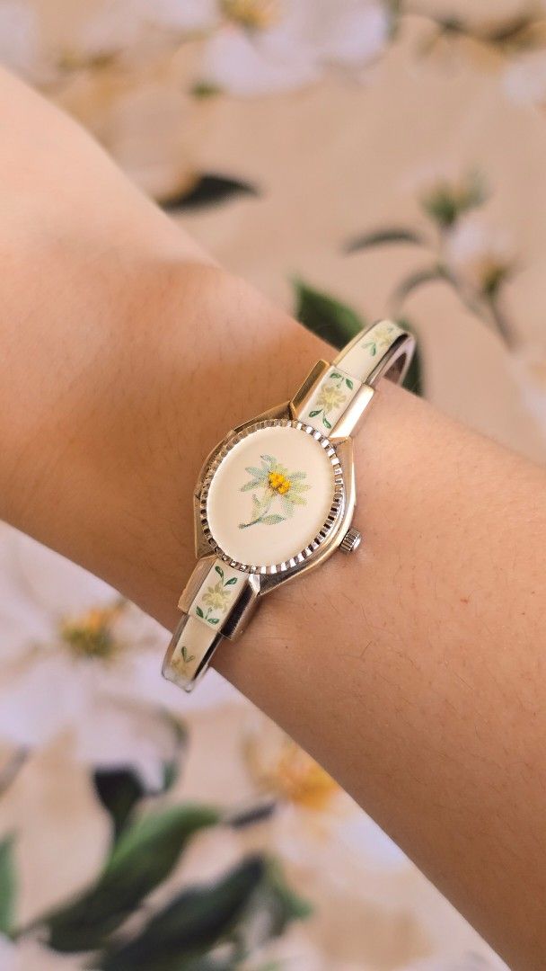 Vintage Andre Mouche Peekaboo Bangle Watch (Category: Women's Watches) located in Silang. Submitted by thewornhour (Listing ID 1461793811, Image 3). Description: Vintage André Mouche Swiss Enamel Bangle Watch – Hand-Painted Edelweiss Flower Locket ✔ All original watch ✔ Case: 16.8mm including crown ✔ Up to 16cm ✔ Movement: Precision Swiss Quartz ✔ Design: Unique piece features a rigid gold-tone bangle decorated with exquisite, hand-painted floral