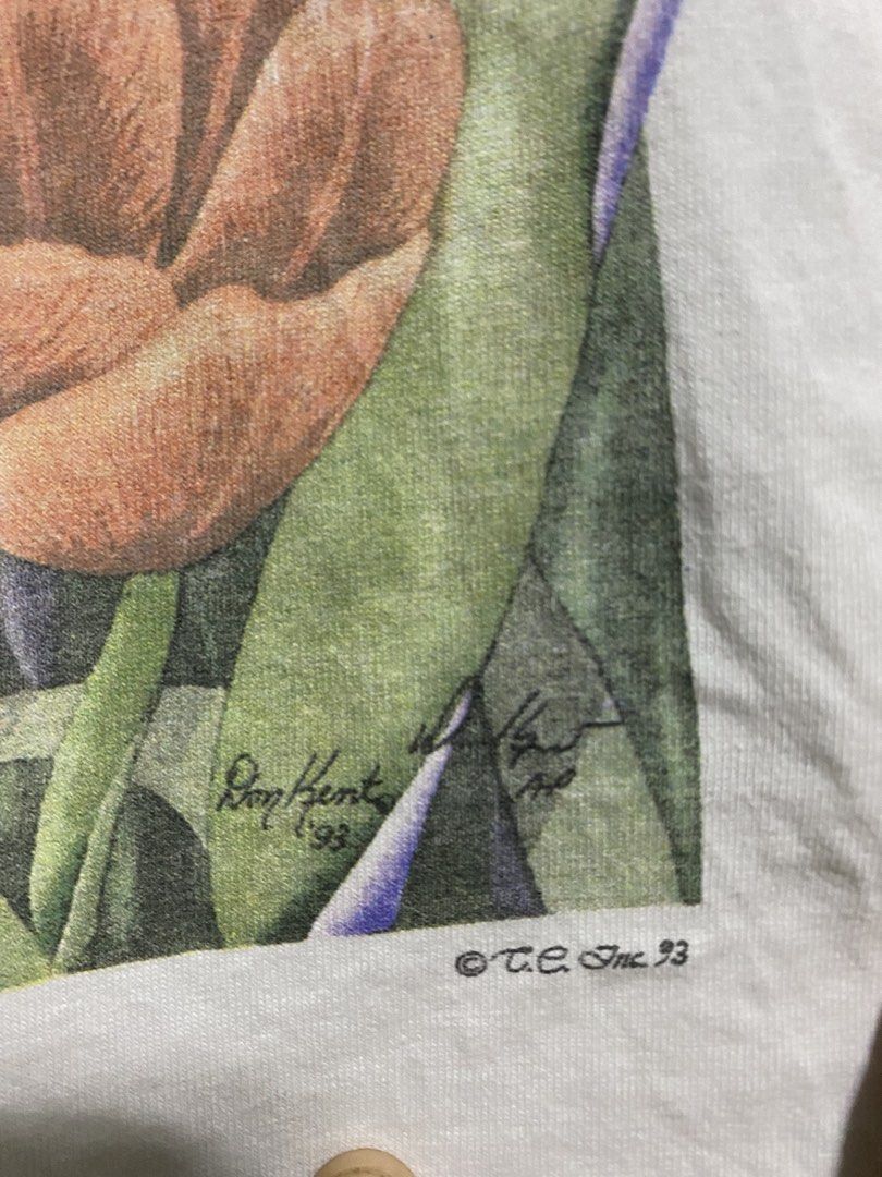 Vintage art tee (Category: Tshirts & Polo Shirts ) located in Manila. Submitted by callejage69430 (Listing ID 1461730378, Image 3). Description: 22 width 28 Length This is a vintage 1990s white t-shirt featuring a graphic illustration of a bunny rabbit nestled among colorful tulips.