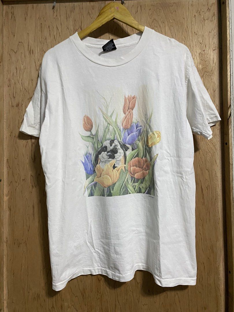 Vintage art tee (Category: Tshirts & Polo Shirts ) located in Manila. Submitted by callejage69430 (Listing ID 1461730378, Image 1). Description: 22 width 28 Length This is a vintage 1990s white t-shirt featuring a graphic illustration of a bunny rabbit nestled among colorful tulips.