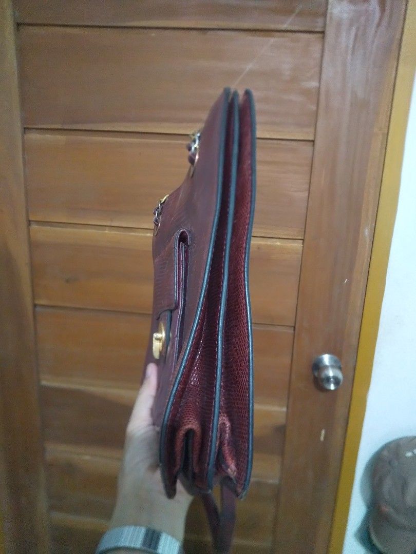 Vintage Burgundy Lizard Embossed Chain Shoulder Bag (Category: Shoulder Bags) located in Binan City. Submitted by rpute (Listing ID 1461576967, Image 3). Description: - Color: Burgundy - Texture: Lizard embossed - Closure: Gold-tone turn-lock - Strap: Chain strap - Features: Front pocket with quilted detail - Condition: Some exterior and corner wear, interior is clean - Style: Classic shoulder bag.