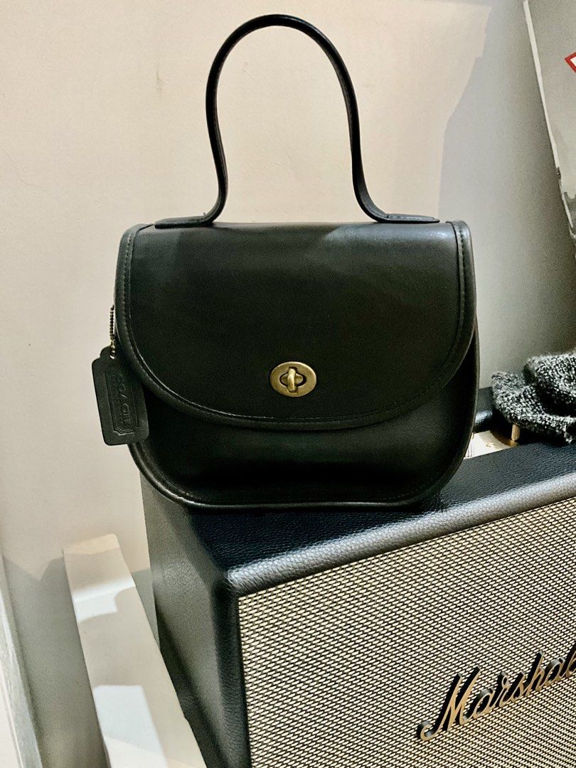 Vintage Coach BellaCourt in Black (Category: Luxury Bags & Wallets) located in Manila. Submitted by karendepan95717 (Listing ID 1461593972, Image 1). Description: - Classic vintage black Coach leather handbag with string - Features a turnlock closure - Top handle for easy carrying - Original Coach hangtag included - Timeless and versatile design - Ideal for everyday use or special occasions *VINTAGE.