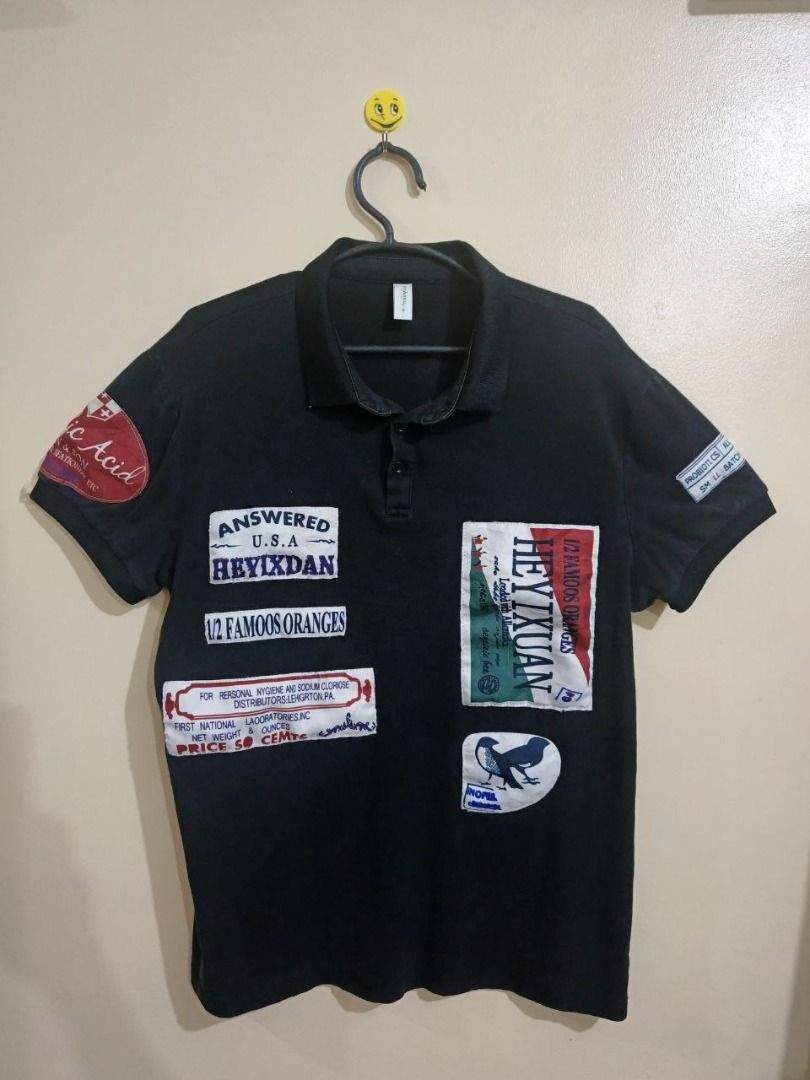 Vintage Graphic Patch Work Short-Sleeve Polo Shirt (Category: Tshirts & Polo Shirts ) located in Taguig. Submitted by wenwen_21 (Listing ID 1461562741, Image 1). Description: Unisex vintage-style black short-sleeve polo shirt featuring heavy graphic patch details across the front, back, and sleeves. Unique Y2K/streetwear look. Item Details: Fit / Style: Unisex (Fits Small to Medium) Dimensions: 20" Width x 26" Length Condition: Good condition (No