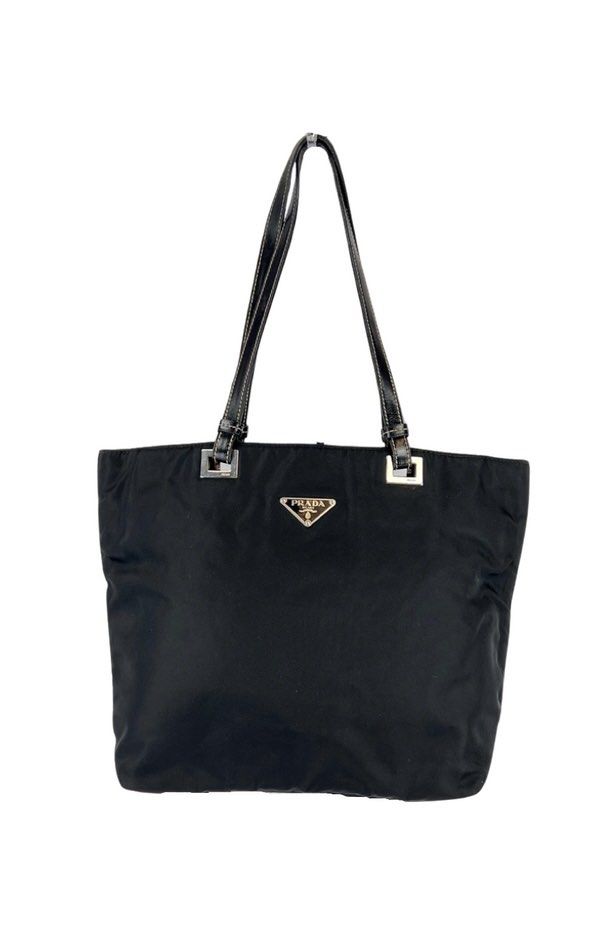 vintage Prada Tessuto nylon tote (Category: Shoulder Bags) located in Plaridel. Submitted by ilovebubu28 (Listing ID 1461793171, Image 1). Description: Pre-owned Prada black Tessuto nylon tote bag featuring dual flat leather top handles, silver tone hardware, triangular Prada logo plaque on front and zip closure top with pull tab. Nylon lined main compartment with single zip pocket..