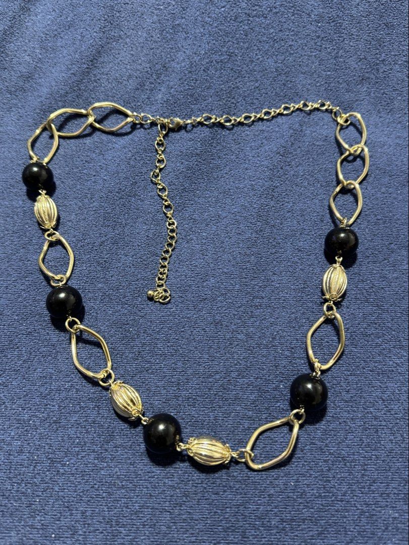 vintage-style gold-tone chain accessory (Category: Necklaces) located in Angeles City. Submitted by zyeplustradings (Listing ID 1461635754, Image 1). Description: vintage-style gold-tone chain accessory configured with open-link geometric sections alternating with smooth black spherical beads and textured, ribbed gold melon beads..