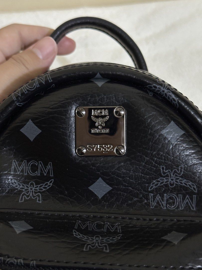 MCM Visetos Side Stud X-Mini Stark Bebe Boo Backpack Black (Category: Backpacks) located in Las Pinas. Submitted by bagsbyshai (Listing ID 1461700594, Image 2). Description: This is the authentic MCM Visetos Side Stud X-Mini Stark Bebe Boo Backpack in Black. This backpack is crafted of MCM monogram print coated canvas in black. It features a studded patch pocket on either side, polished ruthenium hardware, a rolled leather handle, an adjustable s