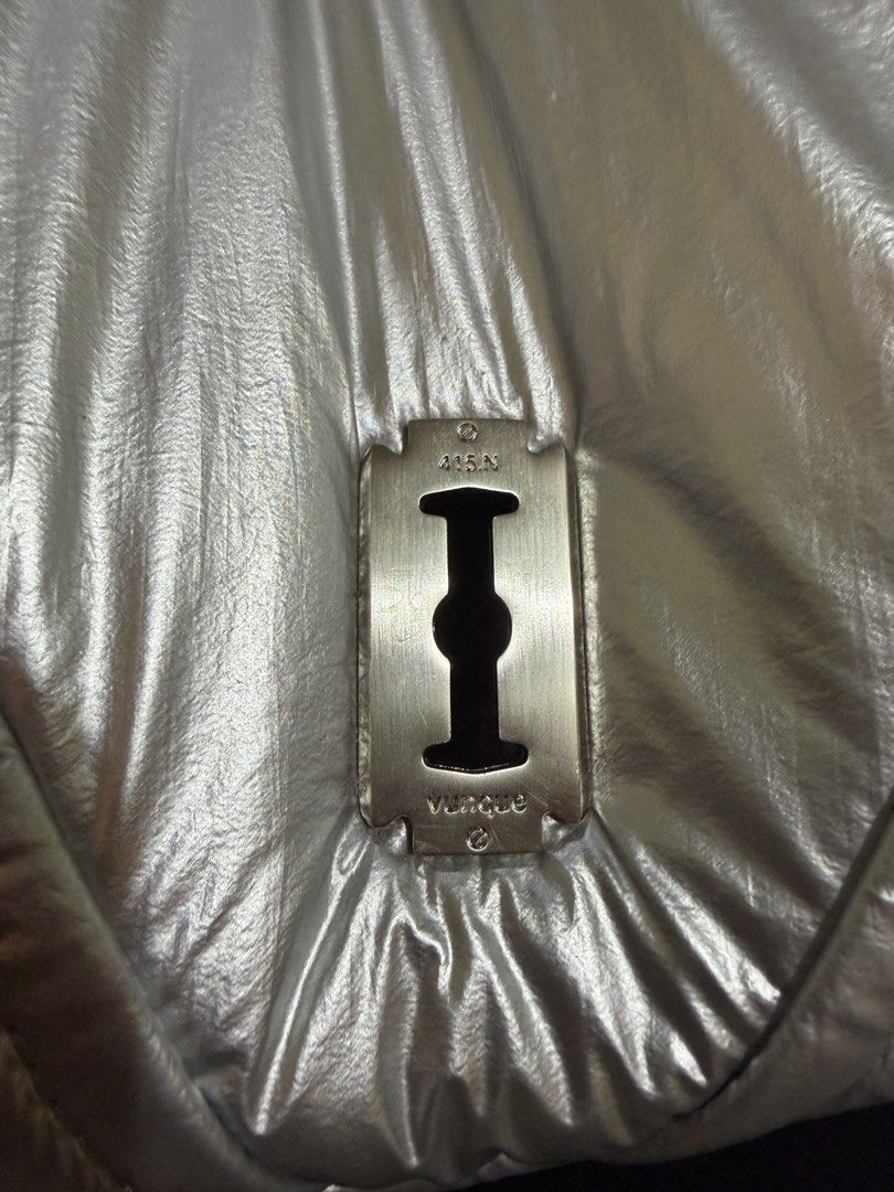 Vunque Silver Puffer Shoulder Bag (Category: Luxury Bags & Wallets) located in Tarlac. Submitted by jzennoroyy-32960 (Listing ID 1461601919, Image 2). Description: - Brand: Vunque - Color: Cool Silver - Style: Puffer Bag - Unique Feature: Razor blade detail on the front - Interior Color: Light Purple - Strap: Detachable - Features: Spacious interior, suitable for essentials - Versatile: Great for everyday use or a night out.